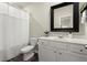 Well-lit bathroom featuring a white vanity with a framed mirror and a shower with a white curtain at 2110 Prichard Park Dr, Kennesaw, GA 30144