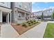 Charming front porch with chairs and manicured landscaping next to a sidewalk and the front yard at 2110 Prichard Park Dr, Kennesaw, GA 30144