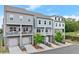 Row of three story townhomes, showcasing stone foundations and private balconies at 2110 Prichard Park Dr, Kennesaw, GA 30144