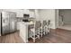 Kitchen with island seating, stainless steel appliances, and white cabinets at 2110 Prichard Park Dr, Kennesaw, GA 30144