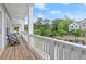 Relaxing outdoor porch featuring wood flooring and a charming view of the green common area and adjacent buildings at 2110 Prichard Park Dr, Kennesaw, GA 30144