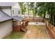 Aerial view of backyard with a deck, fire pit, and green space, surrounded by trees at 2805 Pineland Ave, Atlanta, GA 30340