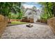 Stone patio in backyard, with a custom fire pit and wood fence at 2805 Pineland Ave, Atlanta, GA 30340