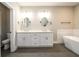 Bright bathroom featuring a soaking tub, a double vanity, and modern finishes at 2805 Pineland Ave, Atlanta, GA 30340