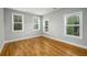 Bright bedroom featuring hardwood floors and three windows with natural light at 2805 Pineland Ave, Atlanta, GA 30340
