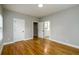 A gray bedroom leads to a bathroom through a white door; hardwood floors visible at 2805 Pineland Ave, Atlanta, GA 30340