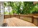 Large wooden deck with wood railing, overlooking a green backyard and mature trees at 2805 Pineland Ave, Atlanta, GA 30340