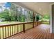 Spacious wood porch with natural wood railings overlooking a green front yard and trees at 2805 Pineland Ave, Atlanta, GA 30340