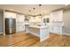 White kitchen with stainless steel appliances, white cabinets, and pendant lights at 2805 Pineland Ave, Atlanta, GA 30340