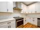 Close-up of kitchen featuring white cabinets, stainless steel appliances, and subway tile backsplash at 2805 Pineland Ave, Atlanta, GA 30340