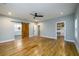 Main bedroom featuring hardwood floors, a ceiling fan, a barn door, and a walk-in closet at 2805 Pineland Ave, Atlanta, GA 30340