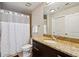 Full bathroom with granite countertops, dark wood cabinetry, and shower with tub at 3324 Peachtree Rd # 1719, Atlanta, GA 30326