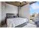 Bedroom with a queen bed, carpeted floor, and a skyline view from the floor to ceiling windows at 3324 Peachtree Rd # 1719, Atlanta, GA 30326