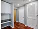 Hallway features a built-in desk, white cabinets, hardwood floors, and three doors at 3324 Peachtree Rd # 1719, Atlanta, GA 30326
