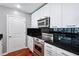 Kitchen with white cabinets, stainless steel appliances, and a black backsplash at 3324 Peachtree Rd # 1719, Atlanta, GA 30326