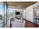 Living room with hardwood floors, modern furniture, floor-to-ceiling windows, and a balcony overlooking city views at 3324 Peachtree Rd # 1719, Atlanta, GA 30326