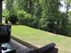 Lush backyard featuring a grassy slope with mature trees. Great for outdoor activities at 3630 Deaton Trl, Buford, GA 30519