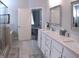 A spacious bathroom with double vanity, soaking tub, and glass-enclosed shower at 3630 Deaton Trl, Buford, GA 30519