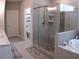 This bathroom features a large glass shower, soaking tub, and tiled floors at 3630 Deaton Trl, Buford, GA 30519