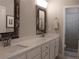 This bathroom features double sinks, marble countertops and a view to the walk-in shower at 3630 Deaton Trl, Buford, GA 30519