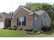 A well-maintained single-Gathering home featuring a blend of brick and siding, complemented by a green lawn and landscaping at 3630 Deaton Trl, Buford, GA 30519