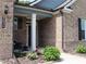 Inviting front entrance with brick facade, white column, and manicured landscaping for a welcoming curb appeal at 3630 Deaton Trl, Buford, GA 30519