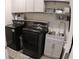 This laundry room features a washer, dryer, and sink at 3630 Deaton Trl, Buford, GA 30519