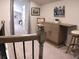 Cozy loft area with a stylish bar, bar stools, and artwork, perfect for entertaining and relaxation at 3630 Deaton Trl, Buford, GA 30519