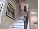 Elegant staircase with dark wood banister and white risers, complemented by artwork on the wall at 3630 Deaton Trl, Buford, GA 30519