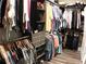 Organized walk-in closet with hanging rods, shelves, and drawers for ample storage at 3630 Deaton Trl, Buford, GA 30519