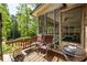 Outdoor deck featuring a grill, seating, and views of the backyard and forest at 1602 Shamrock Se Trl, Smyrna, GA 30080