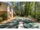 A green backyard with a covered pool, home exterior, and fence at 1602 Shamrock Se Trl, Smyrna, GA 30080