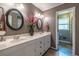Elegant bathroom with a double sink vanity, modern lighting, and a stylish design at 1602 Shamrock Se Trl, Smyrna, GA 30080