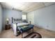 Well-lit bedroom with blue walls, carpeted floor, and a queen bed with matching decor at 1602 Shamrock Se Trl, Smyrna, GA 30080
