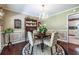 Bright dining room with chandelier and hardwood floors exudes classic elegance and charm for gatherings at 1602 Shamrock Se Trl, Smyrna, GA 30080