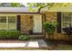 Home's entry with a white door, brick exterior, and neatly trimmed landscaping at 1602 Shamrock Se Trl, Smyrna, GA 30080