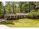 Beautiful brick home with an attached garage and a lush, green front lawn and mature trees at 1602 Shamrock Se Trl, Smyrna, GA 30080