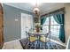 Eat-in kitchen features floral decor, a table set for four, and bright natural light at 1602 Shamrock Se Trl, Smyrna, GA 30080