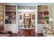 Living room view of dining room, featuring hardwood floors and built-in bookshelves at 1602 Shamrock Se Trl, Smyrna, GA 30080