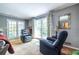 Bright living room with neutral walls, comfortable chairs, and access to patio at 1602 Shamrock Se Trl, Smyrna, GA 30080