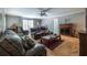Cozy living room features a fireplace, plush seating, and a ceiling fan at 1602 Shamrock Se Trl, Smyrna, GA 30080