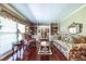 Elegant living room with hardwood floors, built-in bookshelves, and a view into the dining room at 1602 Shamrock Se Trl, Smyrna, GA 30080