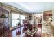 Living room with hardwood floors, built-in bookshelves, and large windows providing natural light at 1602 Shamrock Se Trl, Smyrna, GA 30080