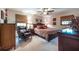Spacious main bedroom features a dark wood furnishings, ceiling fan, and ample natural light at 1602 Shamrock Se Trl, Smyrna, GA 30080