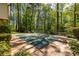 A pool surrounded by a concrete patio and covered in a dark green cover at 1602 Shamrock Se Trl, Smyrna, GA 30080