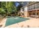 A covered pool surrounded by patio space, adjacent to a yard and home exterior at 1602 Shamrock Se Trl, Smyrna, GA 30080