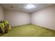 A blank room featuring carpeted floors with boxes of gardening equipment at 1602 Shamrock Se Trl, Smyrna, GA 30080