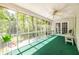 Relaxing screened porch with ceiling fan and view of the backyard and forest at 1602 Shamrock Se Trl, Smyrna, GA 30080