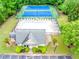Aerial view showcasing a pool and tennis court, with the clubhouse, nestled in a lush, green community at 1738 Honey Tree Pl, Hoschton, GA 30548