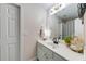 Bright bathroom featuring a white vanity, black faucet, and decorative accents at 1738 Honey Tree Pl, Hoschton, GA 30548